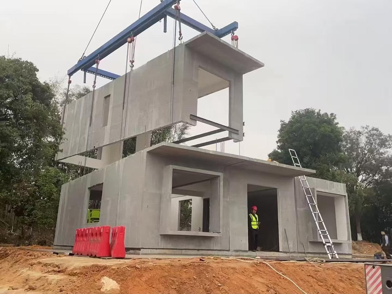 A precast concrete module being lifted into position by crane on a modular building site